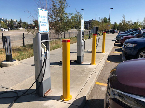 Yellow powder coated bolt-down bollards installed